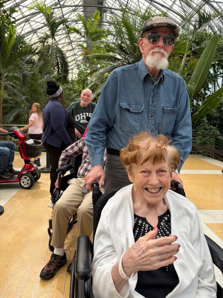 Residents explore the tropical gardens during a community outing to Krohn Conservatory.