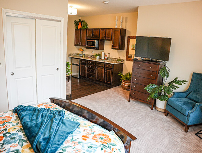 a wide shot of a studio at Traditions at Camargo. Showing the living space and kitchen